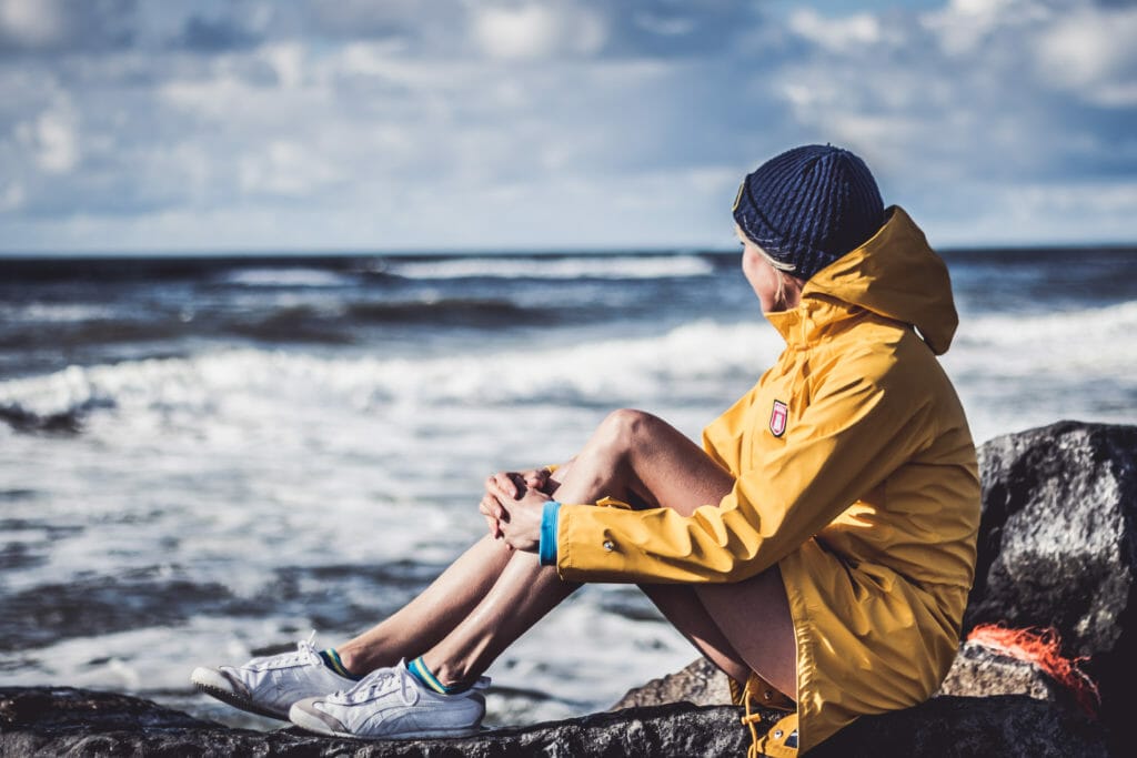 Hvide Sande -Girl in a yellow rain coat looking at the water