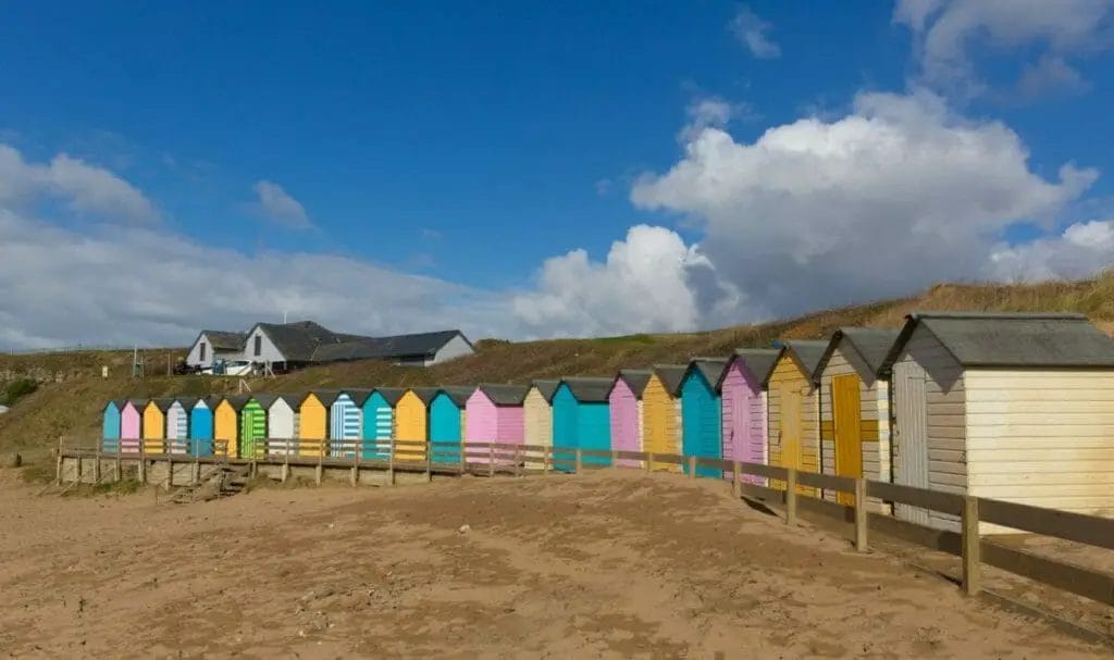 Colorful beach huts in Bude- Best places to stay Cornwall